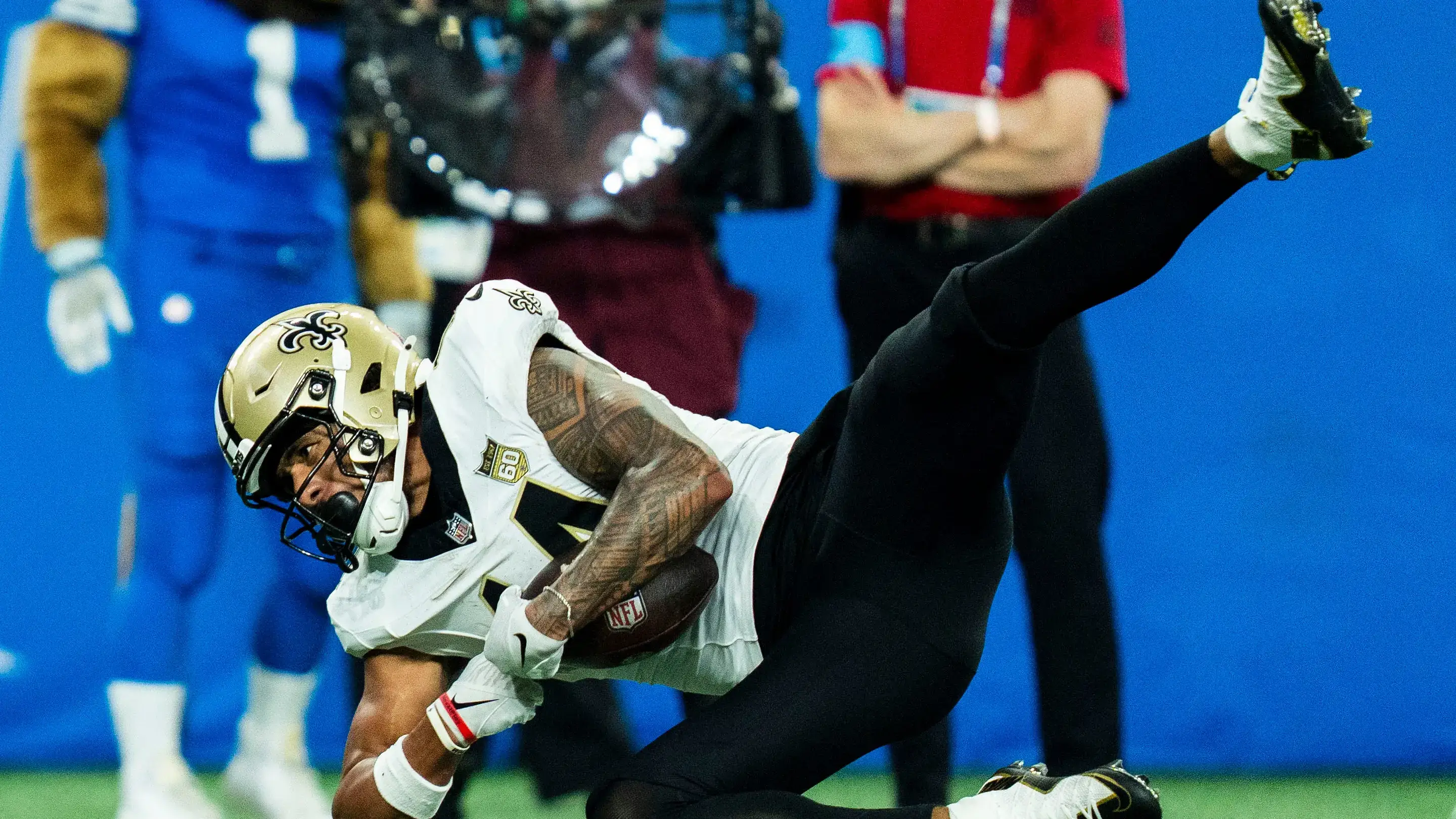 Saints' Devaughn Vele secures first down vs. Lions at Ford Field on Sept 13, 2026